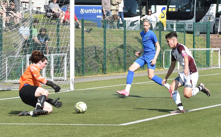 Ramstein goalkeeper Favian Pierre-Louis beats Vilseck's Jessie Sanchez to the ball during a pool-play match on May 15, 2023, in Reichenbach-Steegen, Germany.