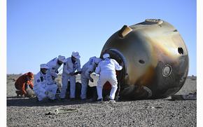 Workers open up the capsule of the Shenzhou-17 manned spaceship after it lands successfully at the Dongfeng landing site in north China's Inner Mongolia Autonomous Region, on Tuesday, April 30, 2024. 