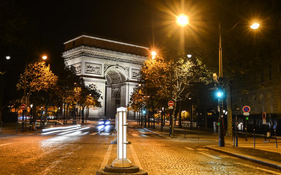 A nocturnal view of the Arc de Triomphe, one of the most famous monuments in Paris.