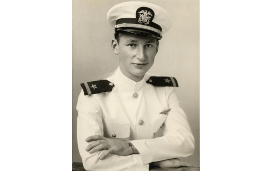 A vertical, black and white photo of a man in a sailor uniform.