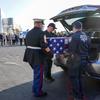 Teresa Irwin, left, sister of Marine Capt. Grady Kurpasi, watches as Marine First Sgt. Timothy La Sage, center, and Port Authority police officer place his remains into an waiting car at New York's John F. Kennedy International Airport, Friday, May 19, 2023, in New York. The remains of a U.S. Marine veteran who had been missing in Ukraine for more than a year will be returned to his family in eastern North Carolina later Friday, according to the group bringing the remains back to the U.S. (AP Photo/Mary Altaffer)