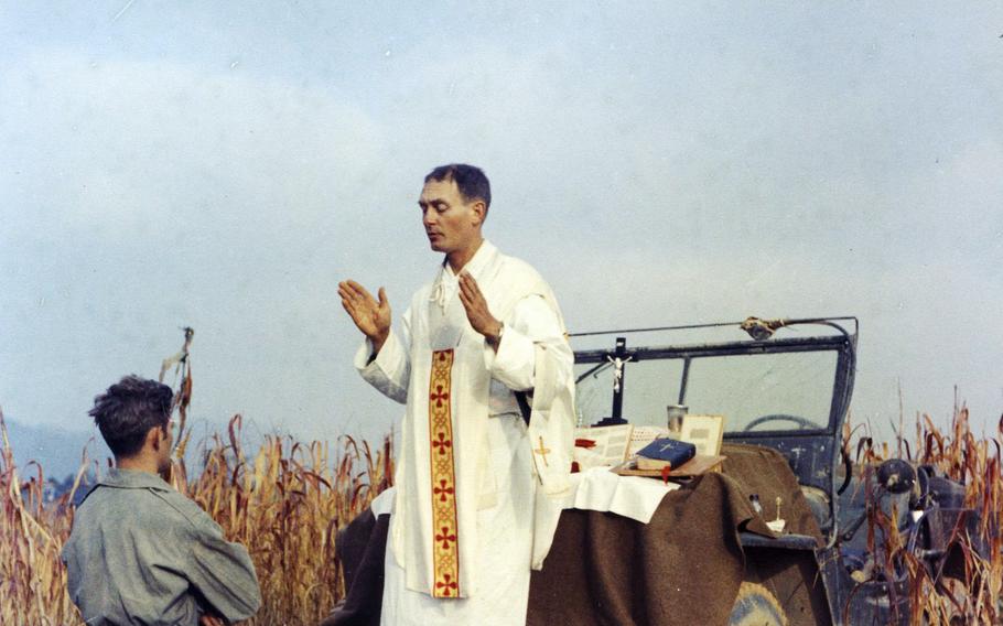 Father Emil Kapaun celebrates Mass using the hood of his jeep as an altar, as his assistant, Patrick J. Schuler, kneels in prayer in Korea on Oct. 7, 1950, less than a month before Kapaun was taken prisoner. Kapaun died in a prisoner of war camp on May 23, 1951. 