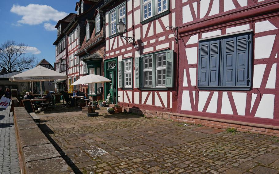 People enjoy refreshments at a cafe among the half-timbered houses that line Buedingen, Germany’s marketplace. 