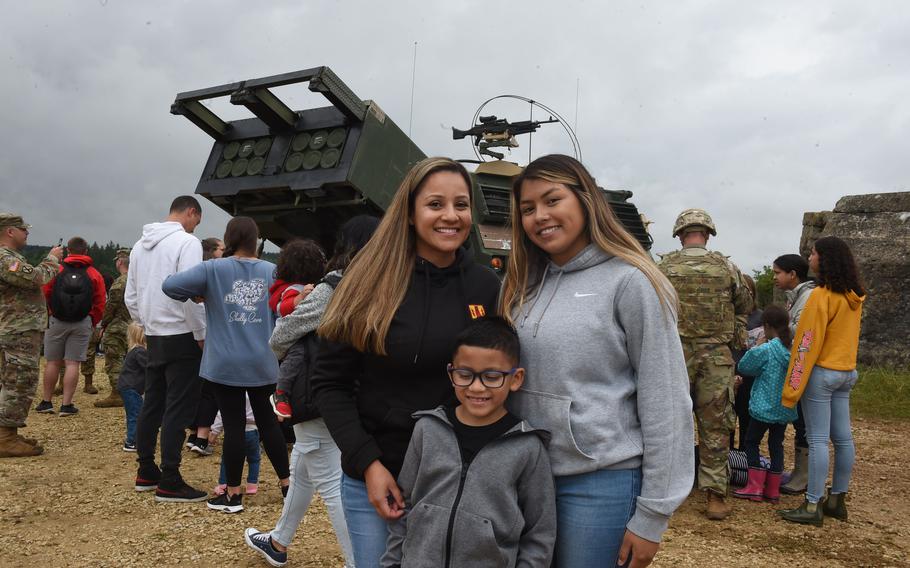 Sgt. Monica Salazar, left, a soldier with the 41st Field Artillery Brigade, poses with her two children, Rafael, center, and Jasmine, right, at Grafenwoehr Training Area on Aug. 5, 2021. The 41st FAB hosted a family day during a live-fire training exercise the unit conducted.