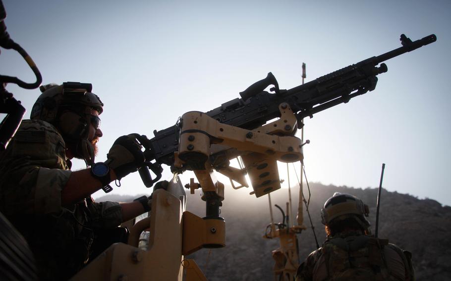 U.S. Special Forces soldiers look for enemy fighters moving on a mountainside during a firefight, during an operation in Afghanistan's Laghman province in 2016.