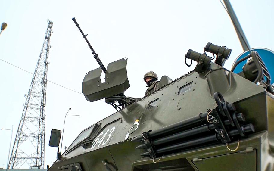 A Kazakh soldier stands atop of a military vehicle at a check point in Kazakhstan, on Friday, Jan. 7, 2022. 