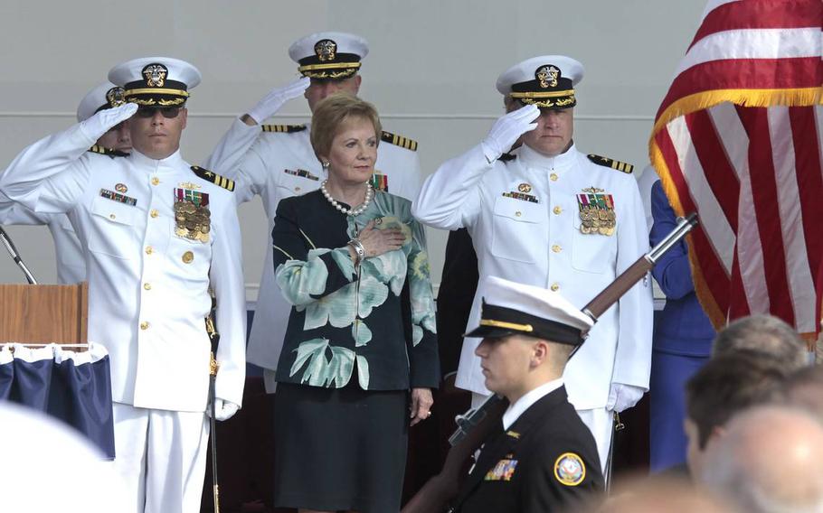 Rep. Kay Granger stands at attention with Cmdrs. Randy Blankenship, left, and Warren Cupps for the opening of the commissioning ceremony for the USS Fort Worth in Galveston, Texas, on Sept. 22, 2012.