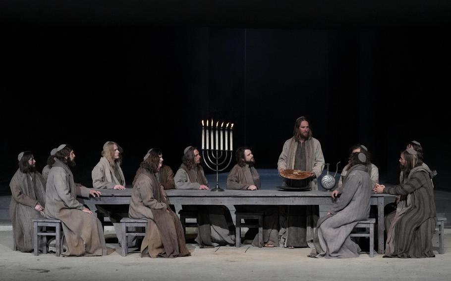 Frederik Mayet as Jesus performs during the rehearsal of the 42nd Passion Play in Oberammergau, Germany, Wednesday, May 4, 2022. The mix of Christian and Jewish influences on the current performance is vividly illustrated during the depiction of the Last Supper, when a huge Menorah is lit on the table and the disciples of Jesus recite both Hebrew prayers and the Christian Lord’s Prayer.