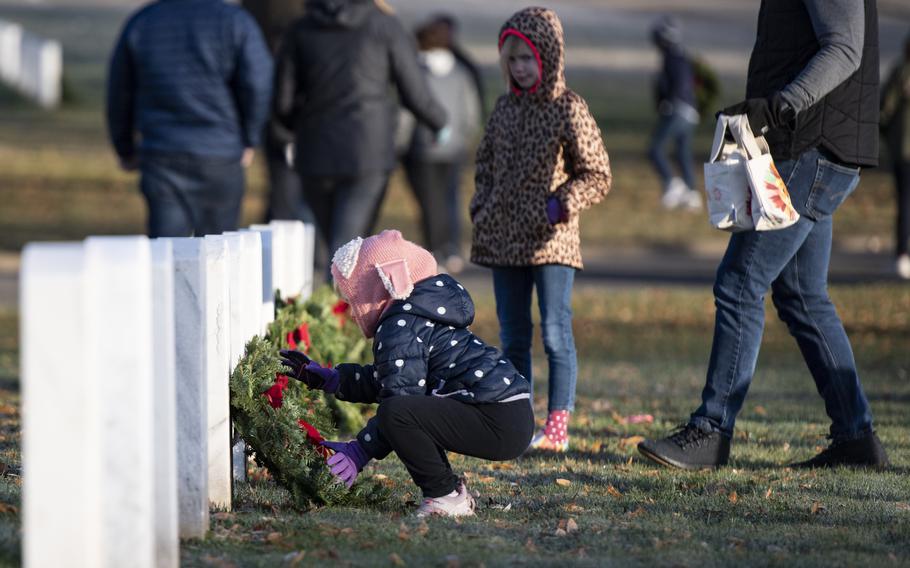 Volunteers participate in the 32nd Wreaths Across America Day in Section 59 of Arlington National Cemetery, Arlington, Va., Dec. 16, 2023. 
