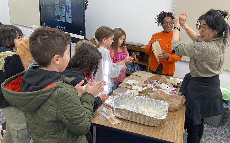 Fujiyo Banks shows fourth-graders how to make onigiri, a Japanese snack, at John O. Arnn Elementary School near Camp Zama, Japan, on Feb. 15, 2024.