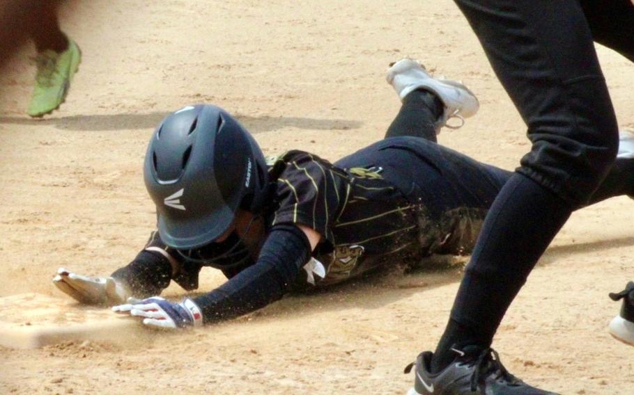 Humphreys' Gracie Farneman dives into third base during Monday's Far East Division I softball tournament. The Blackhawks beat Nile C. Kinnick 30-16 and lost 13-10 to American School In Japan.