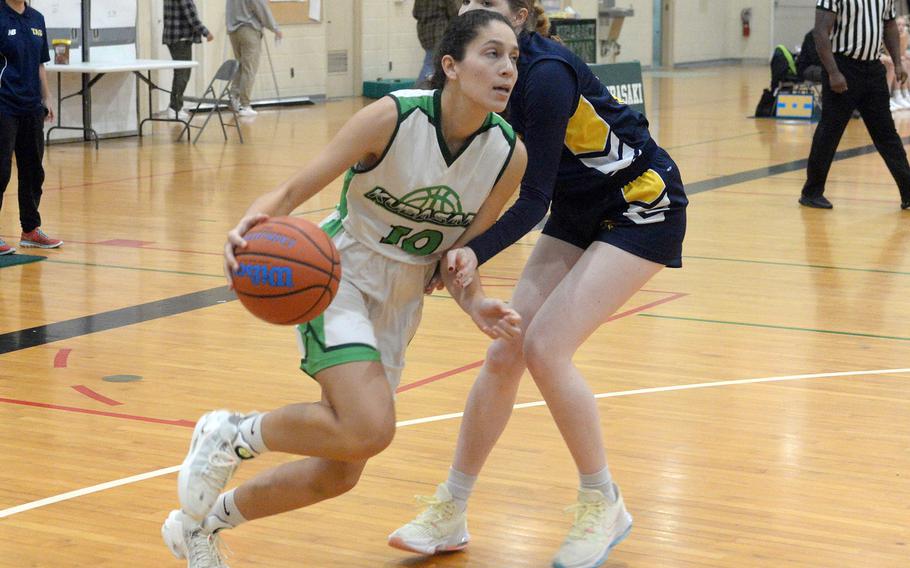 Kubasaki's Soiphia Grubbs drives past a Taipei American defender during Friday's inter-district girls basketball game. The Tigers won 58-31.