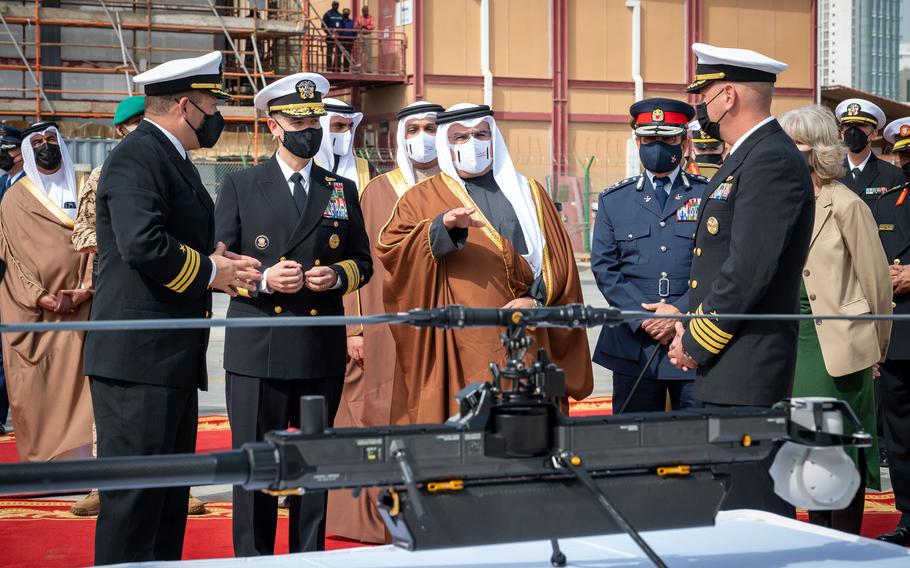 Crown Prince Salman bin Hamad Al-Khalifa, deputy supreme commander and prime minister of Bahrain, center, receives a brief on the GHOST 4 unmanned aerial vehicle at Naval Support Activity Bahrain. A ceremony in Manama Jan. 31, 2022, kicked off the International Maritime Exercise/Cutlass Express 2022.