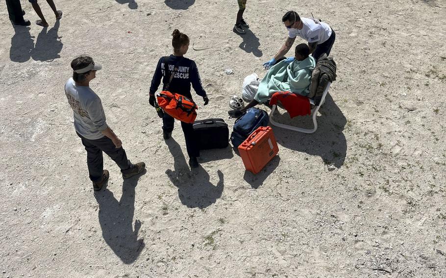 Monroe County emergency personnel tend to an exhausted migrant. 