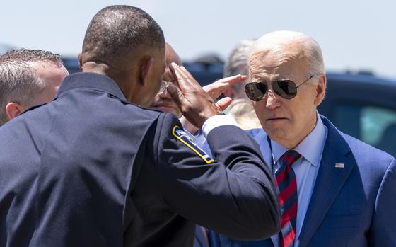 President Joe Biden salutes Charlotte-Mecklenburg Police Department Chief Johnny Jennings as he arrives at Charlotte Douglas International Airport on May 2, 2024.