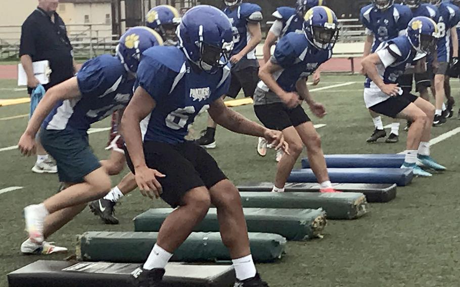 Under the watchful eye of 22nd-year coach Tim Pujol, Yokota players perform agility drills.
