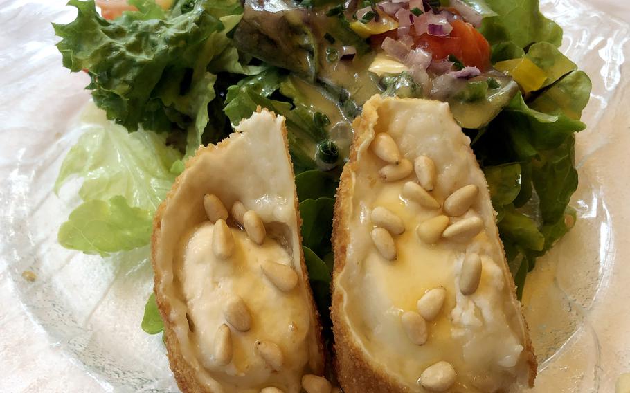 Marinated salad of the season, with baked goat cheese in a crispy coating with honey and pine nuts as served at Forsthaus Rheinblick in Wiesbaden, Germany.