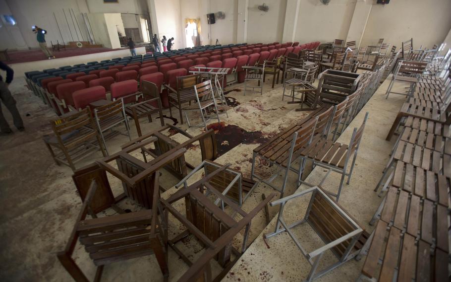 Chairs are upturned and blood stains the floor at the Army Public School auditorium a day after Pakistani Taliban gunmen stormed the school killing 150 people, in Peshawar, Pakistan, Dec. 17, 2014. 