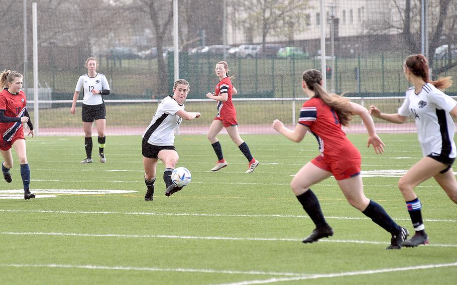 Stuttgart's Bella Henderson passes the ball to teammate Kendall Boudreaux, right, during the first half of Friday evening's game against Lakenheath at Kaiserslautern High School in Kaiserslautern, Germany. Defending are the Lancers' Heidi Amberson, left, and Macy Herring, center right.