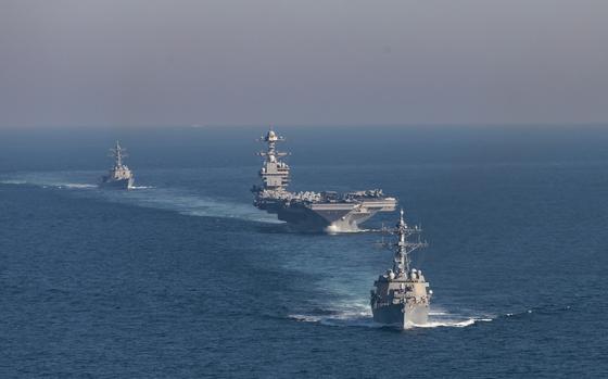 The Arleigh Burke-class guided missile destroyers USS Winston S. Churchill (DDG 81) (front) and USS Bainbridge (DDG 96) (back) escort the world’s largest aircraft carrier, USS Gerald R. Ford (CVN 78), during an integrated phase training event, March 23, 2025. The Gerald R. Ford Carrier Strike Group is underway in the Atlantic Ocean completing integrated naval warfighting training. Composite Training Unit Exercise (COMPTUEX) is the Joint Force’s most complex integrated training event and prepares naval task forces for sustained high-end Joint and combined combat. Integrated naval training provides America’s civilian leaders and commanders highly-capable forces that deter adversaries, underpin American security and economic prosperity, and reassure Allies and partners.(U.S. Navy photo by Mass Communication Specialist 2nd Class Maxwell Orlosky)