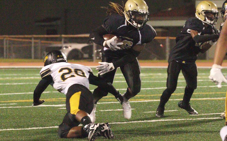 Kadena defender James Kinney tries to bring down Humphreys' Joshua Cannon.