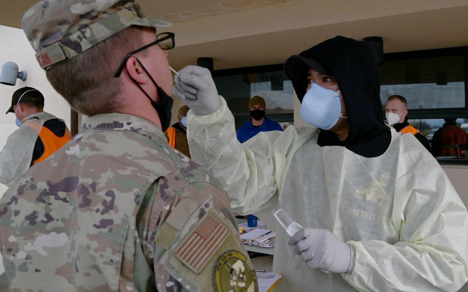 Chief Petty Officer Nathaniel Corpuz, with U.S. Naval Medical Readiness and Training Command Sigonella in Sicily, conducts a COVID-19 test on an airman with the 324th Expeditionary Reconnaissance Squadron at Naval Air Station Sigonella, Jan. 10, 2022. 