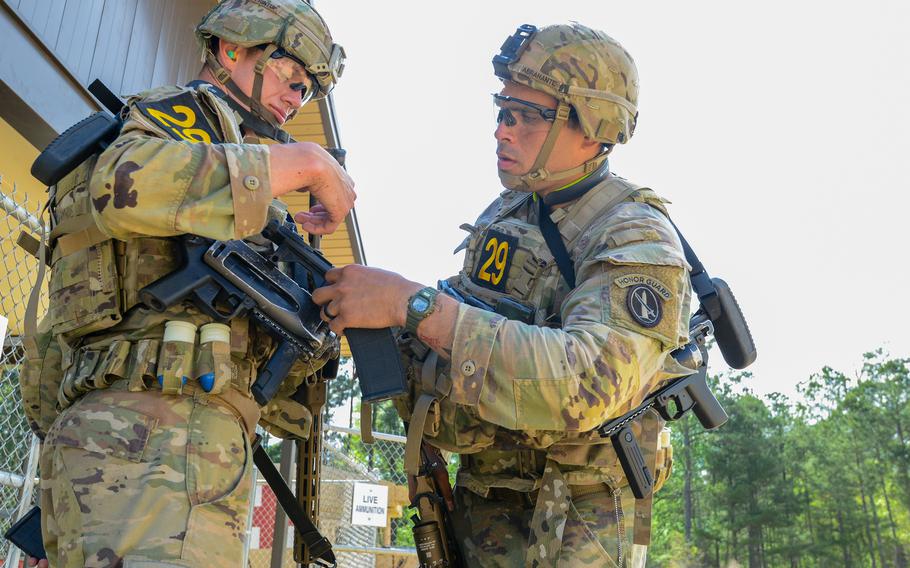 1st Lt. Brendan Printup, left, and Staff Sgt. Joshua Abrahante from the Army’s 3rd Infantry Regiment prepare for a buddy live-fire shoot event at Fort Benning, Ga., during the Best Ranger Competition, Friday, April 14, 2023. 