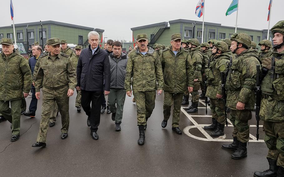 Russian Defense Minister Sergei Shoigu, second from left, inspects mobilized forces near Moscow in this Oct. 1, 2022, undated photo from the Russian Defense Ministry.