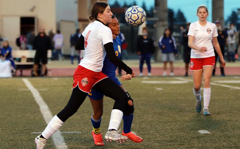 Nile C. Kinnick's Giovanna Kennedy and Yokota's Mariah Hilliard battle for the ball during Friday's DODEA-Japan girls soccer match. The Red Devils won 5-2.