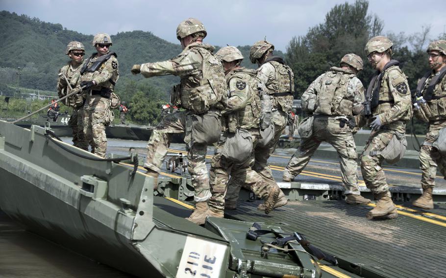 Soldiers from 11th Engineer Battalion, 2nd Infantry Division connect ribbon bridges during a wet-gap crossing drill with South Korean troops at a reservoir in Cheorwon county, near the North Korean border, Thursday, Aug. 31, 2023.