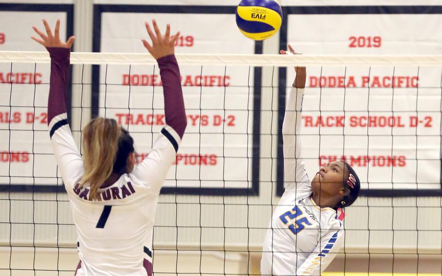 Yokota's Trinity Stegall spikes against Matthew C. Perry's Raelin Reyes during Friday's DODEA-Japan volleyball match. The Panthers won in four sets.