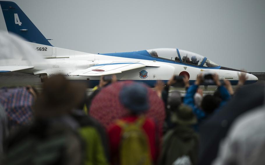 A Blue Impulse T-4 taxis past a crowd attending Friendship Day at Marine Corps Air Station Iwakuni, Japan, Saturday, April 15, 2023.