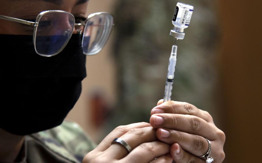 Senior Airman Sara Sanchez prepares COVID-19 vaccine for distribution at MacDill Air Force Base, Fla., in 2021. Nine airmen have filed a class action lawsuit against Air Force Secretary Frank Kendall and Defense Secretary Lloyd Austin because their requests to be exempted from COVID vaccinations were denied.