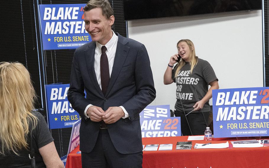 Republican Senate candidate Blake Masters speaks to a voter at the at the Buckeye Community Library Coyote Branch in Buckeye, Ariz., on June 17, 2022.