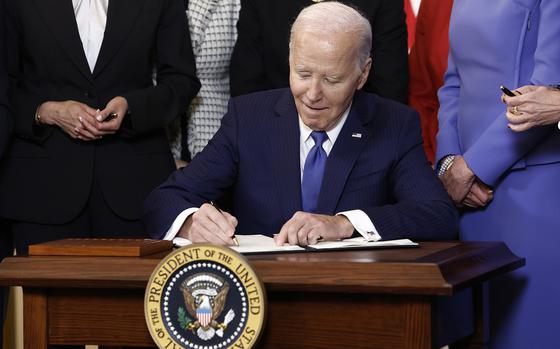 U.S. President Joe Biden signs an executive order on advancing women’s health research and innovation during a Women’s History Month reception in the East Room of the White House on March 18, 2024, in Washington, DC. The event is a part of the Biden administration’s Women’s Health Research initiative. (Anna Moneymaker/Getty Images/TNS)