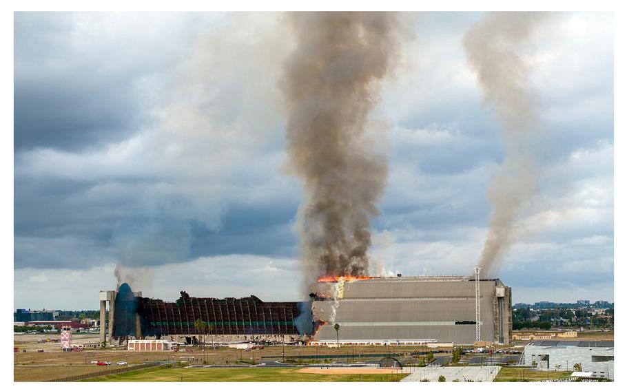 Firefighters work to control a blaze at the north  blimp hangar at the former Marine Corps Air Station in Tustin, Calif., on Nov. 7, 2023. 