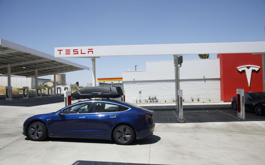 A Tesla Model 3 electric vehicles departs after charging at the Tesla Supercharger station in Kettleman City, Calif., on July 31, 2019. 