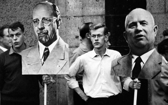 East Berlin, June 1963: Two spectators, obviously concealing their unbounded enthusiasm, hold large cutout photos of East German leader Walter Ulbricht and Soviet Premier Nikita Khrushchev as they await the arrival of the noted Communists' motorcade.

Looking for Stars and Stripes’ historic coverage? Subscribe to Stars and Stripes’ historic newspaper archive! We have digitized our 1948-1999 European and Pacific editions, as well as several of our WWII editions and made them available online through https://starsandstripes.newspaperarchive.com/

META TAGS: Germany; Cold War; USSR; Soviet Union; DDR; Deutsche Demokratische Republik; 