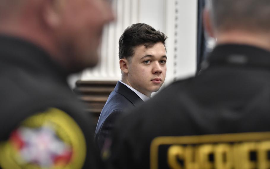 Kyle Rittenhouse, center, looks back as Kenosha County Sheriff’s deputies enter the courtroom to escort him out of the room during a break in the trial at the Kenosha County Courthouse in Kenosha, Wis., on Friday, Nov. 5, 2021. 