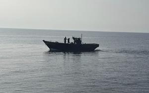 A wooden boat carrying North Korean individuals moves northward across the North Korea sea border.