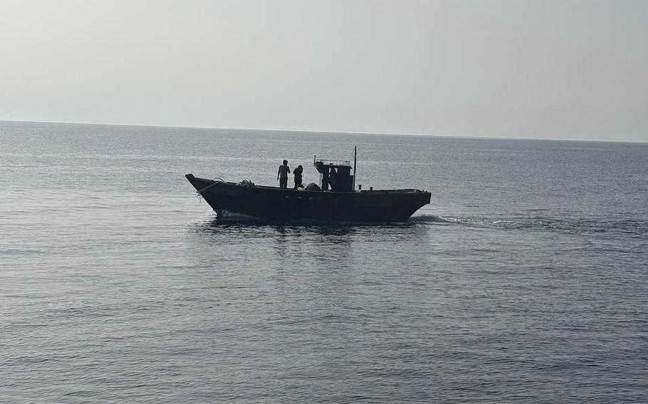 A wooden boat carrying North Korean individuals moves northward across the North Korea sea border.