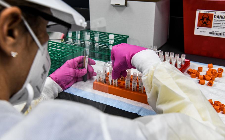 A lab technician sorts blood samples inside a lab for a COVID-19 vaccine study at the Research Centers of America (RCA) in Hollywood, Fla., on Aug. 13, 2020. 