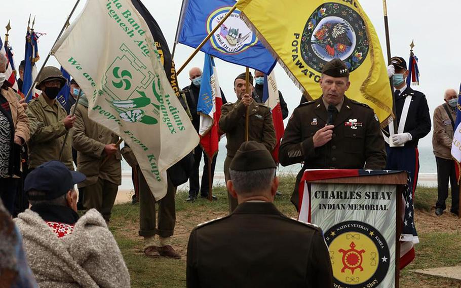 Lt. Gen. John Kolasheski, V Corps commander, speaks at a ceremony June 4, 2021 at Omaha Beach in Normandy, France. The event honored retired Army medic Charles Shay and the service of World War II Native Americans. Shay, standing at the left, facing Kolasheski, landed on the beach during the 1944 D-Day invasion and was later awarded the Silver Star.