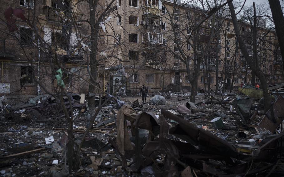 A police officer walks at the site of a bombing that damaged residential buildings in Kyiv, Ukraine, Friday, March 18, 2022. Russian forces pressed their assault on Ukrainian cities Friday, with new missile strikes and shelling on the edges of the capital Kyiv and the western city of Lviv, as world leaders pushed for an investigation of the Kremlin’s repeated attacks on civilian targets, including schools, hospitals and residential areas. 