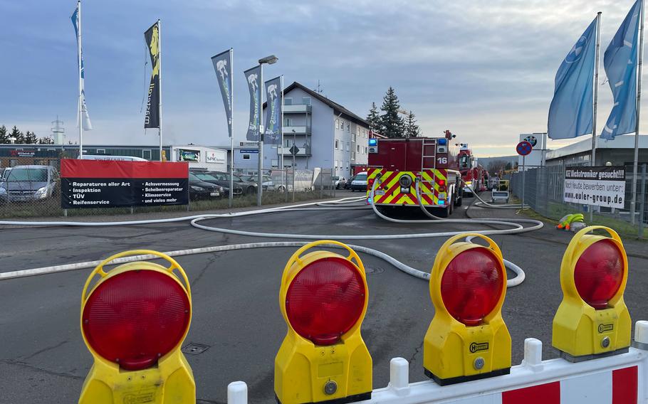 Barricades in the foreground and a fire truck ahead of the barricades