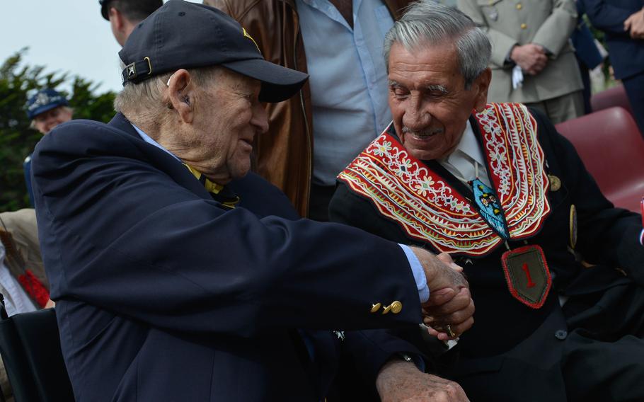 D-Day veterans George Kline and  Charles Shay (right) shake hands at a ceremony in Saint Laurent sur Mer, France, June 5, 2017. 