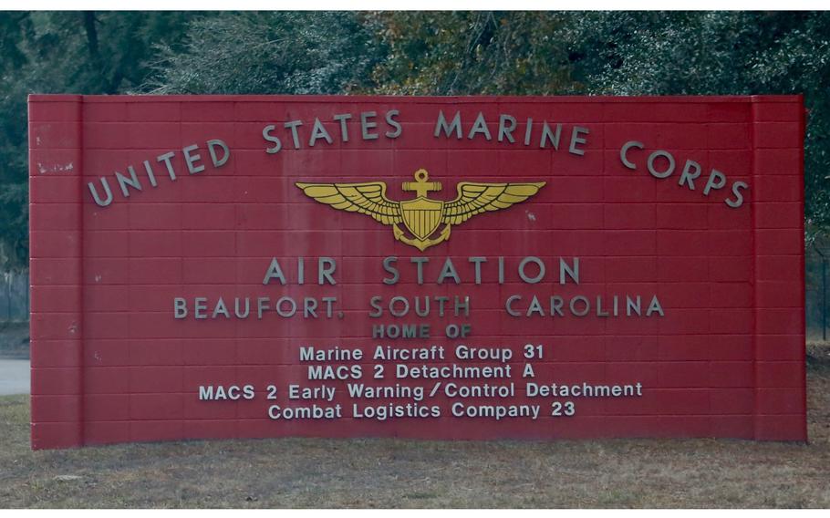 A red sign with silver letters that read “United States Marine Corps Air Station Beaufort South Carolina” and lists the units based there.