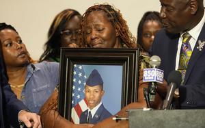 Chantimekki Fortson holds a photo of her son Roger Fortson during a news conference on May 9, 2024, in Fort Walton Beach, Fla.