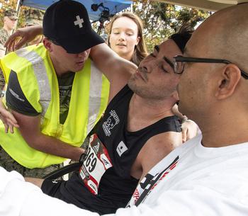 A runner is assisted at the finish line of the 48th Marine Corps Marathon on Sunday, Oct. 29, 2023, in Arlington, Va.