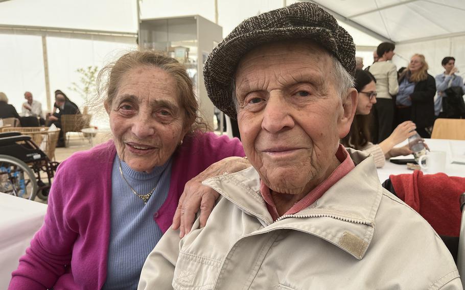 A woman and a man sit together and smile